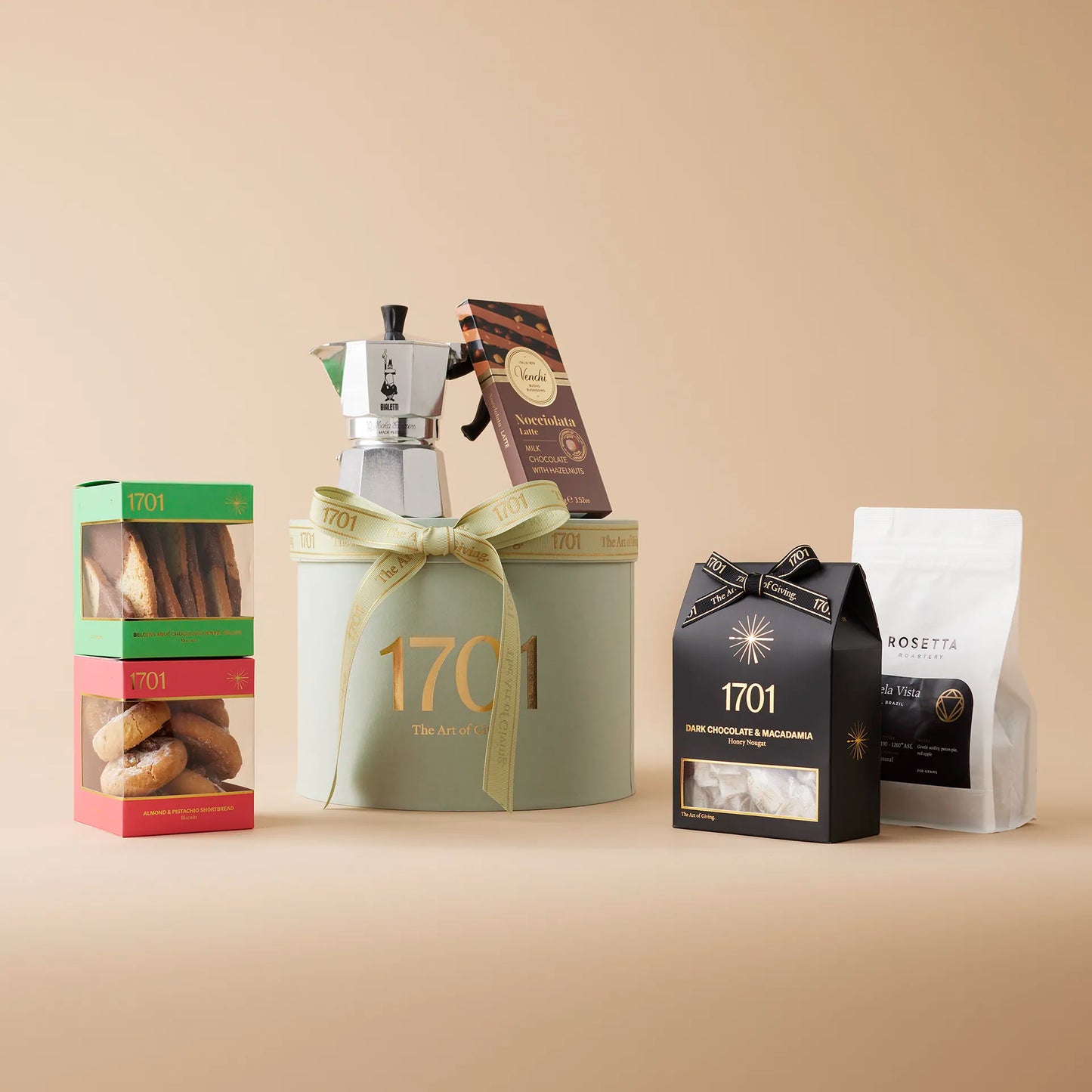 "Always Time for Coffee" gift box containing a handpicked selection of gourmet treats, including handcrafted honey nougat, a selection of biscuits, imported Italian chocolate, a Moka pot, and a bag of Rosetta Roastery coffee. The gift box is shown on a warm background, with the product label visible on the front of the box. The gift box is tied with a ribbon, and a gift tag is visible on the top of the box. This gift is perfect for coffee lovers and is suitable for any occasion.