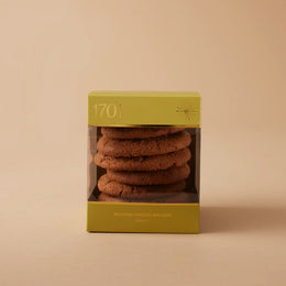 "Belgian Chocolate Chip Biscuits" gift box featuring a 200g box of handmade biscuits with Belgian chocolate chips. The biscuits are presented in a product box on a warm background, with the product label visible on the front of the box. The biscuits are SANHA Halaal approved, making them a perfect gift idea for anyone who appreciates high-quality biscuits made with care.