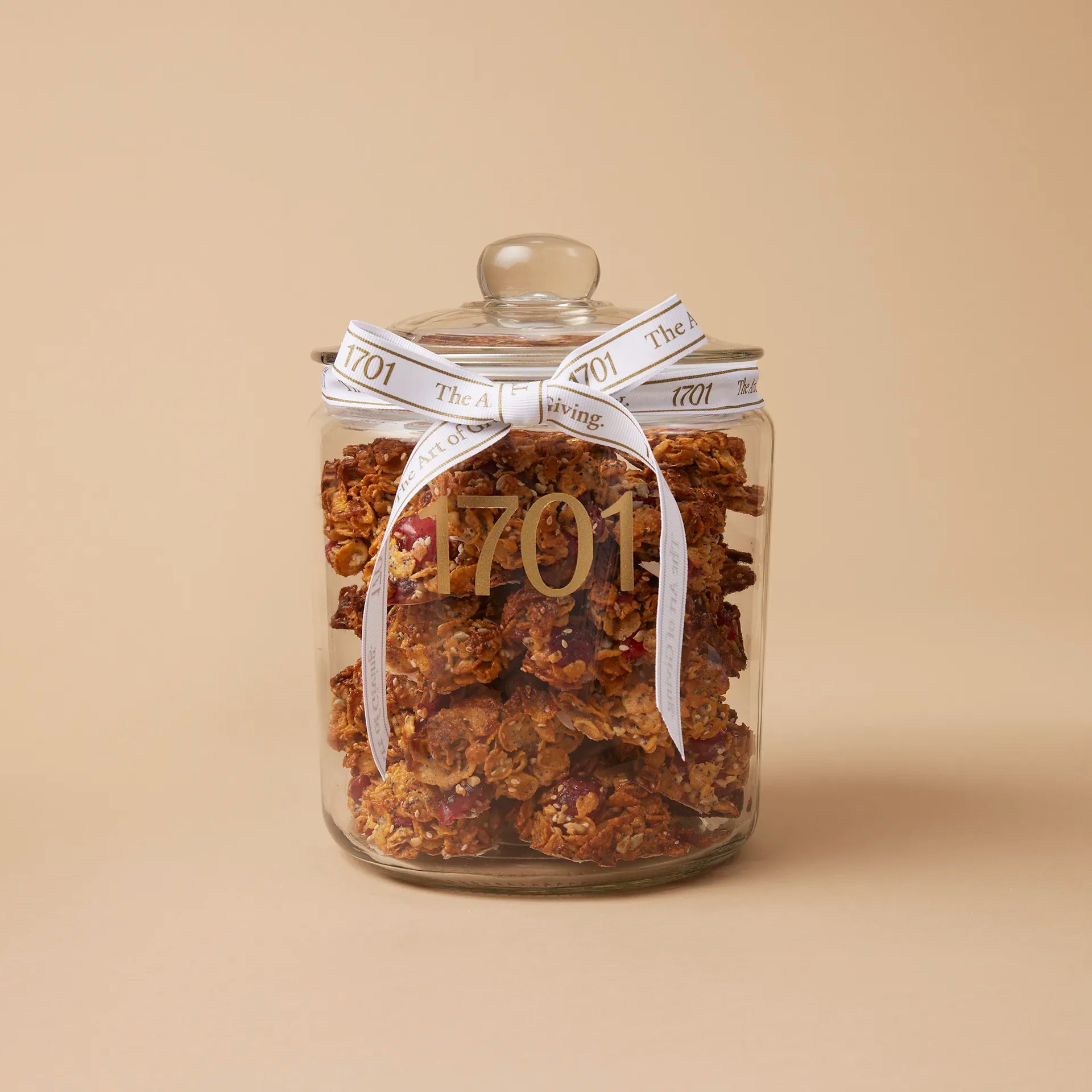 A 1kg glass jar of handmade Crunchy Florentine's biscuits, presented in a glass jar with a hand-tied signature ribbon on a warm background, with the product label visible on the front of the jar. The biscuits are SANHA Halaal approved, making them a perfect gift idea for anyone who appreciates high-quality biscuits made with care.
