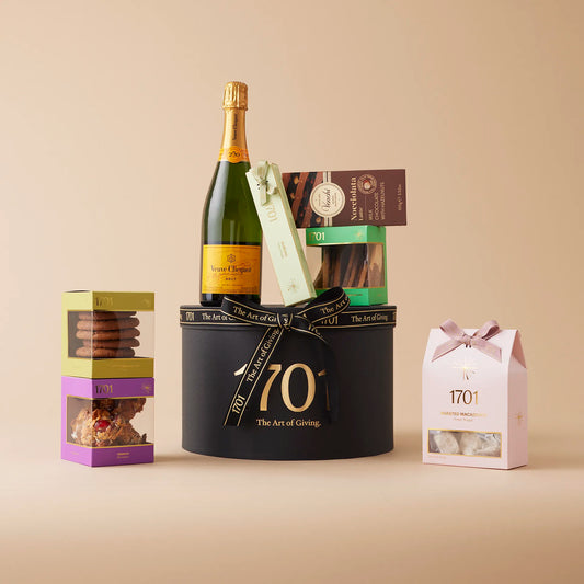 French Vineyards Brut gift box presented in a signature hat box, featuring a bottle of Veuve Cliquot Brut or Rosé, along with a box of handcrafted honey nougat, a nougat bar, and a selection of chocolates and confections. The perfect gift to celebrate special moments with friends and loved ones.