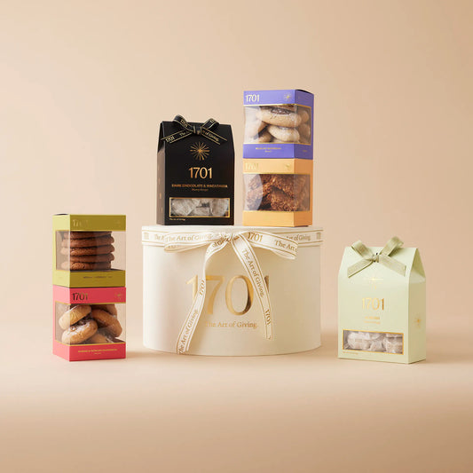 The Montelimar Large Gift Box is presented on a warm background. The gift box is a paper hat box, containing a handpicked selection of the finest treats, including handcrafted honey nougat and four boxes of delectable biscuits. This gift box is named after the town in France where nougat originally comes from, and it's perfect for anyone who enjoys the luxury of the finest treats. This gift box is a great way to show someone how much they mean to you on special occasions or just because.