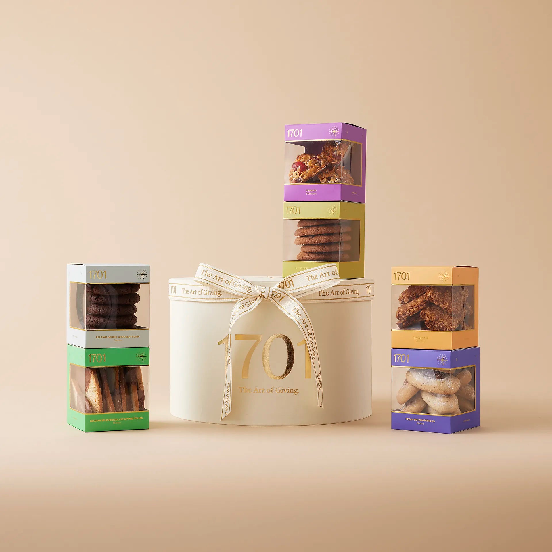 A gift box with an assortment of biscuits in different shapes, sizes, and flavors. The box is presented on a warm background and finished with a hand-tied ribbon, with the product label visible on the front of the box. Perfect for biscuit lovers who appreciate high-quality, handcrafted treats.