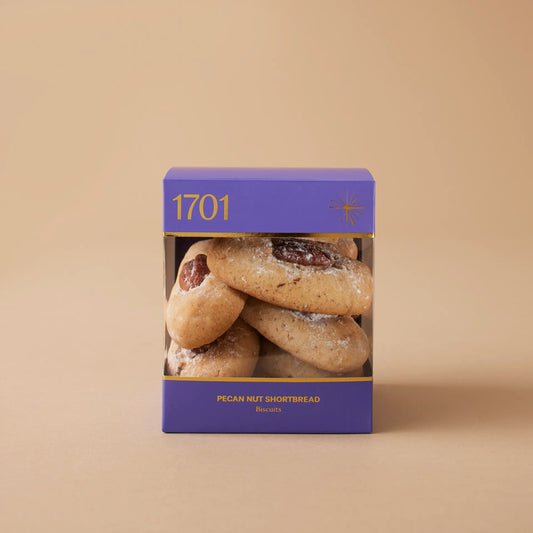 A box of 200g of Pecan Nut Shortbread biscuits presented on a warm background, with the product label visible on the front of the box. The biscuits are SANHA Halaal approved, making them a perfect gift idea for anyone who appreciates high-quality biscuits made with care.